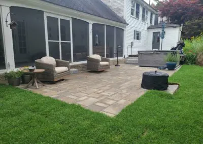 Patio with concrete floors and armchairs -landscape designers near me