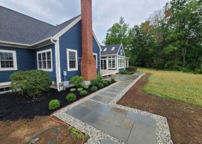 Modern Walkway besides house made out of concrete by Modena NH - hardscapes hudson nh