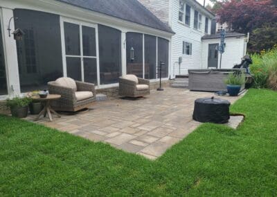 Patio with concrete floors and armchairs -landscape designers near me