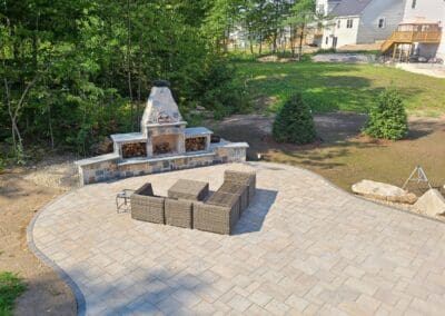 Patio with masonry fireplace by Modena NH - hardscapes hollis nh