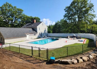 Modern patio with swimming pool, concrete floors and grass - hardscapes amherst nh