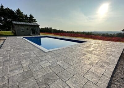In-ground swimming pool with concrete floor around it - fiberglass pools hampstead nh